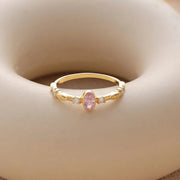 14k Gold filled birthstone cz diamond ring with a pink tourmaline gemstone on a beige background